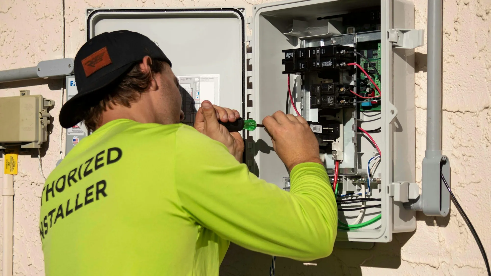 Electrician installing wiring on site
